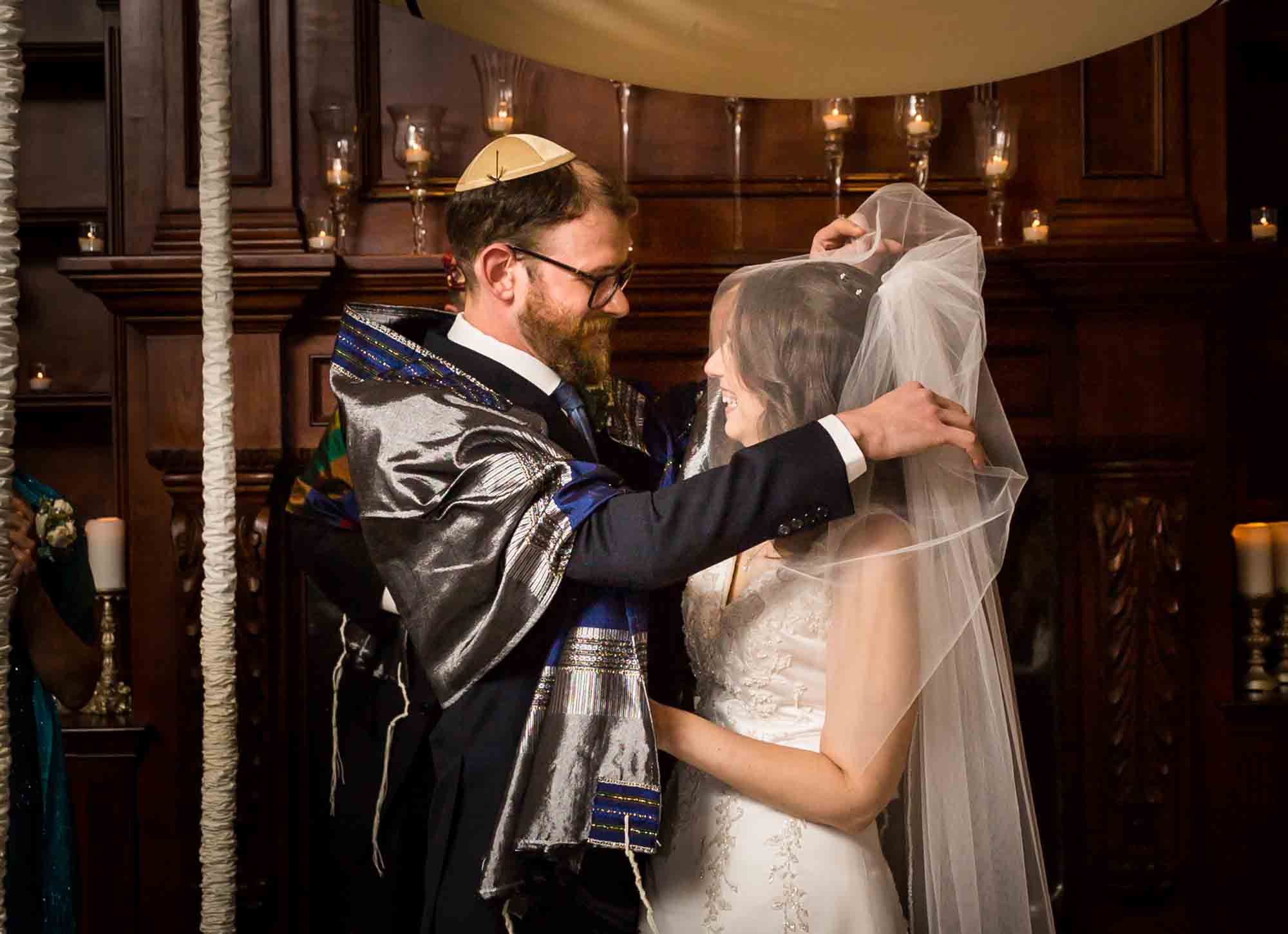 Groom lifting bride's veil for an article on band vs DJ