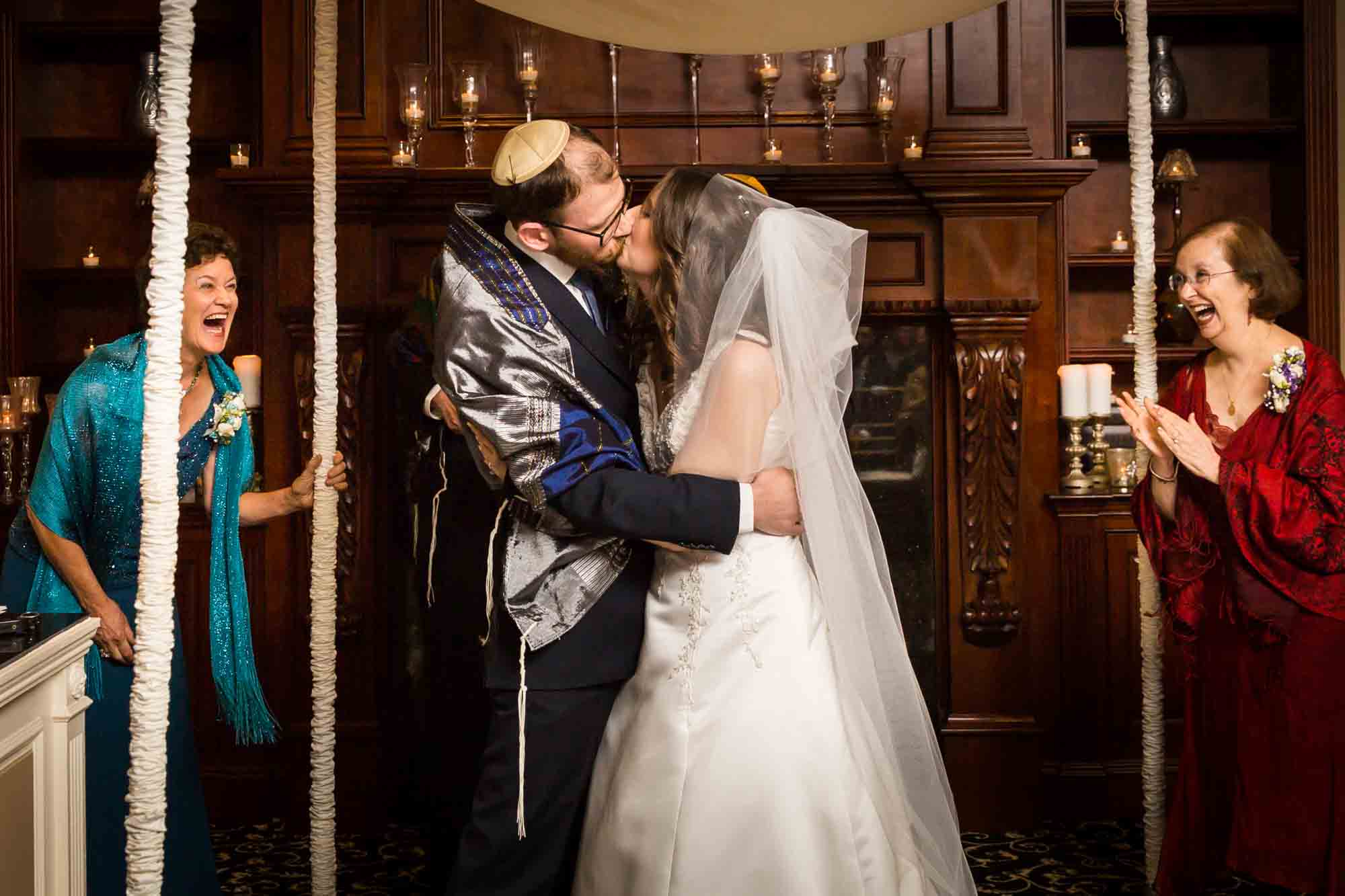 Bride and groom kissing for an article on band vs DJ
