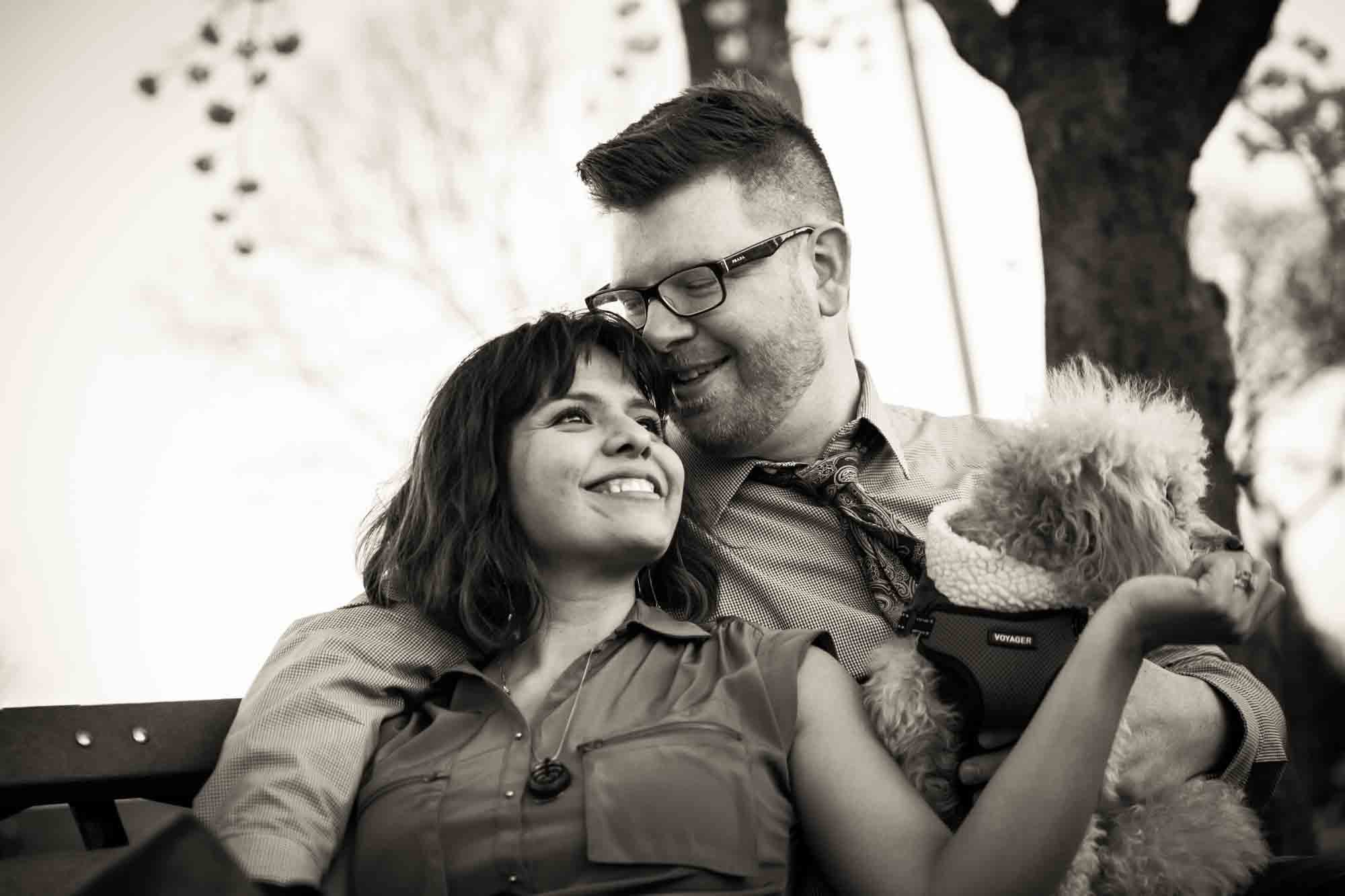 Portrait of engaged couple on park bench for article on cherry blossom photo tips