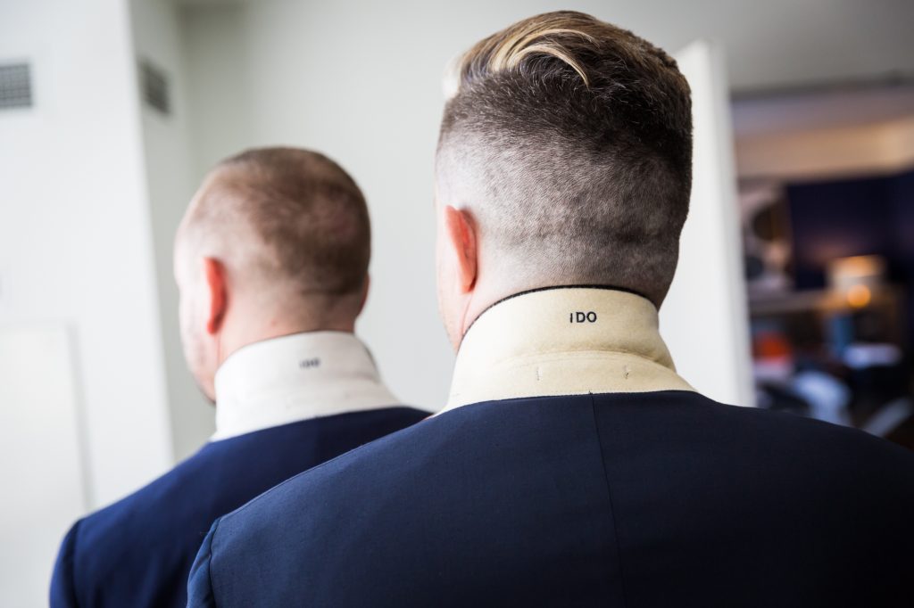 Grooms with embroidered tuxedo jackets at a same sex wedding celebration in Washington DC