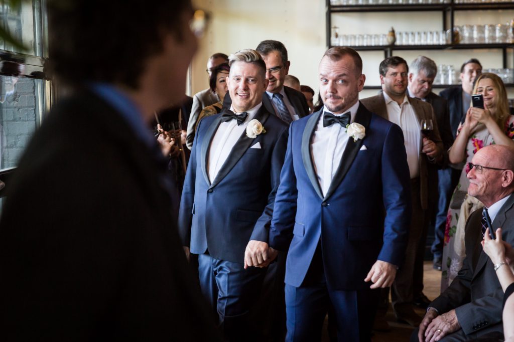 Grooms walking down the aisle at a same sex wedding celebration in Washington DC