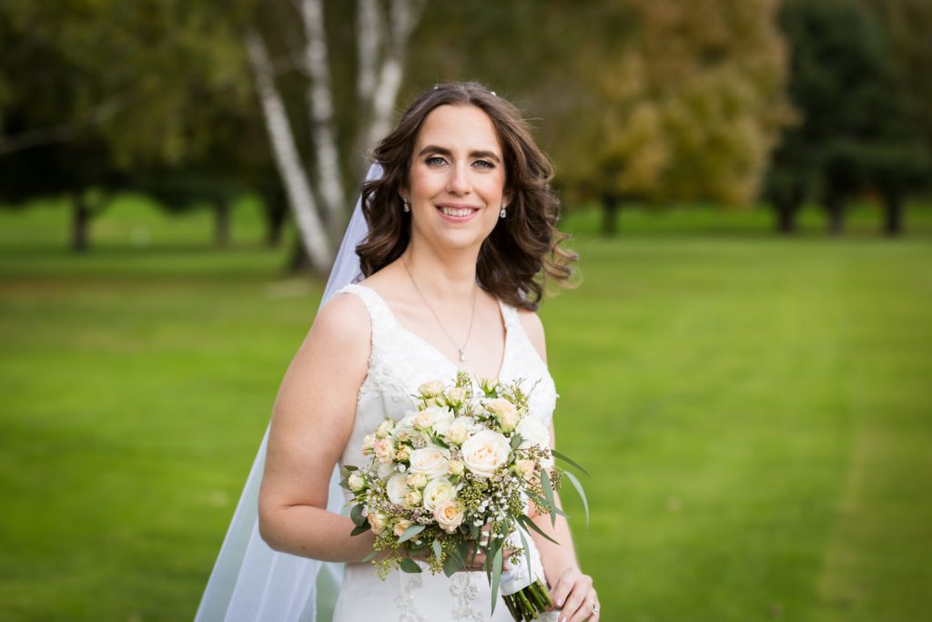 Portrait of bride holding bouquet of flowers