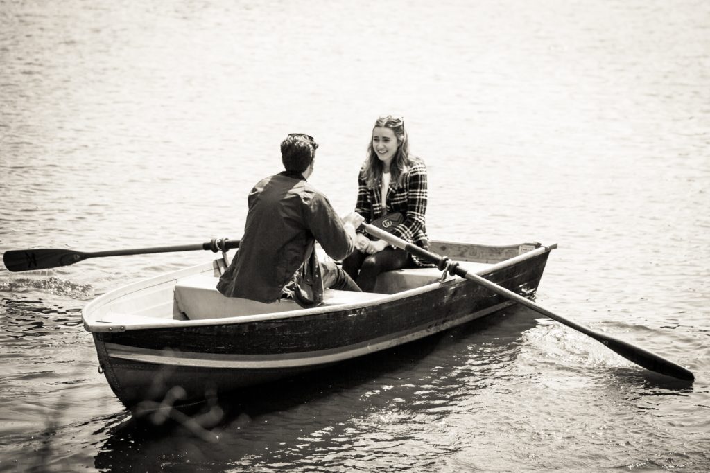 Black and white photo of man and woman in boat
