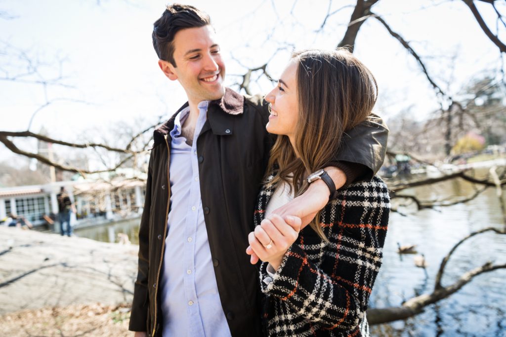 Newly engaged couple walking in Central Park for article on Central Park Lake proposal tips