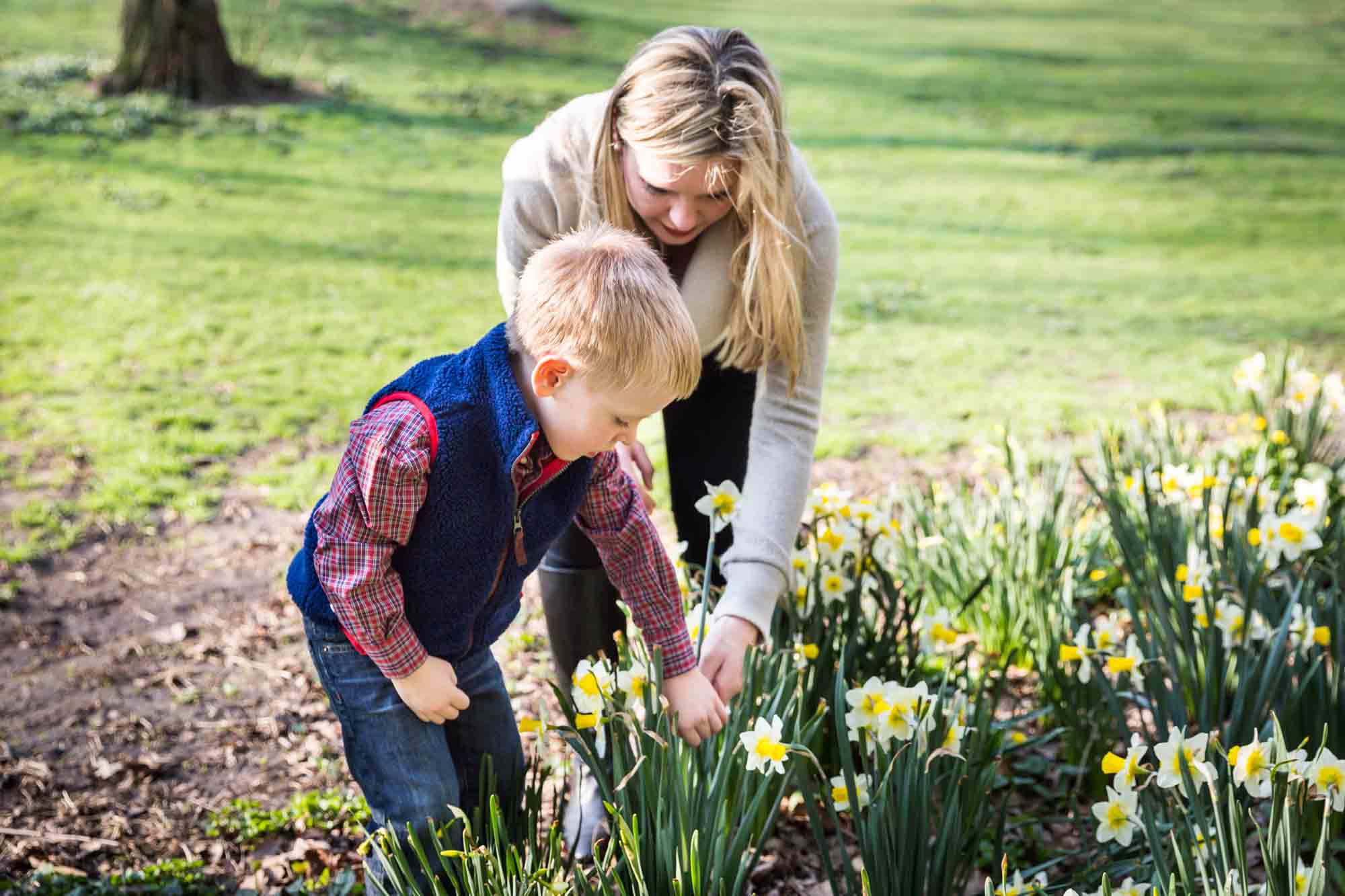 Mother and child picking daffodils for an article on the best family portrait poses
