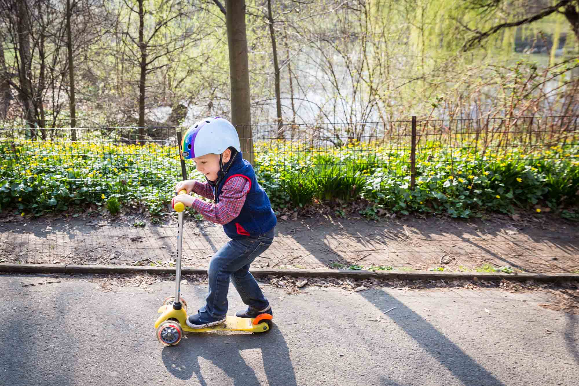 Child on scooter for an article on the best family portrait poses