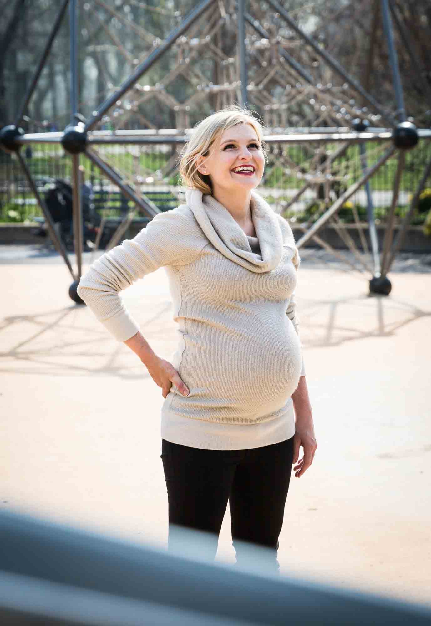 Pregnant mother at playground for an article on the best family portrait poses