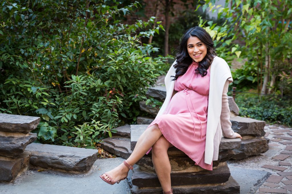 Portrait of a mother-to-be sitting on rock for an article on maternity portrait tips