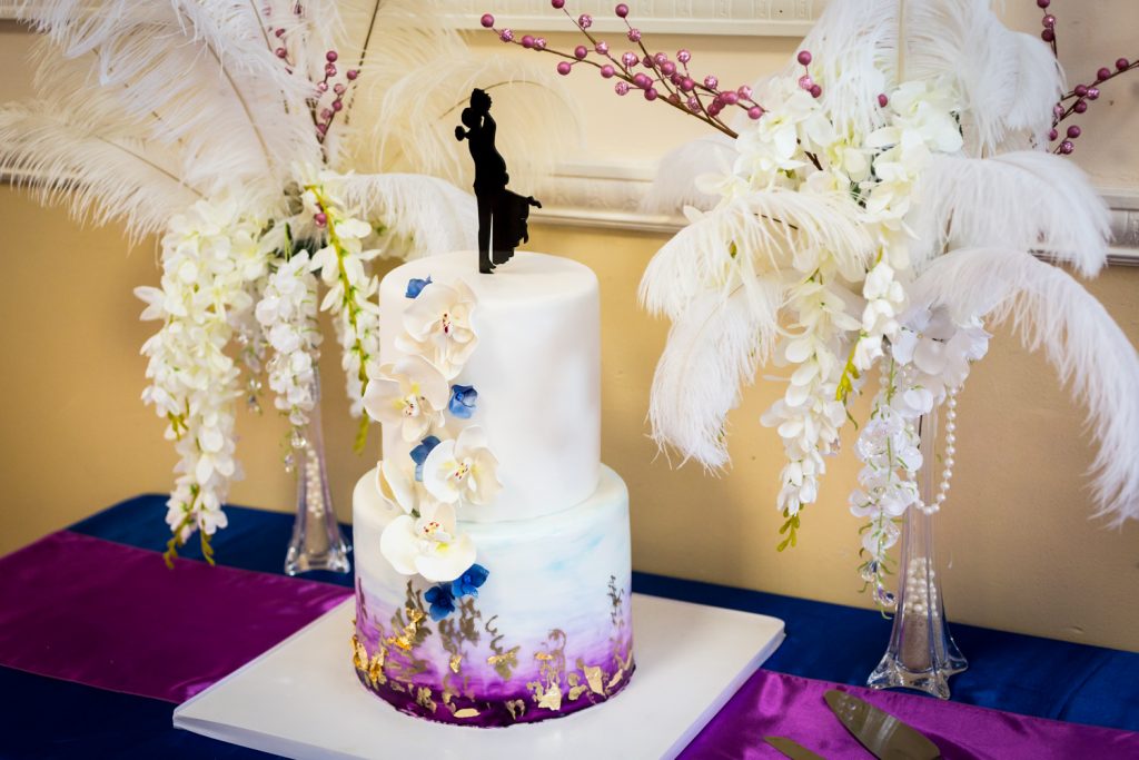 Elaborate wedding cake with orchids and feathers