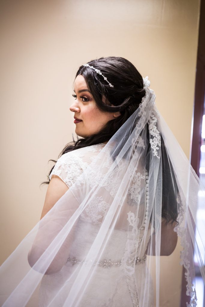Portrait of bride looking over her shoulder for an article on wedding photography timeline tips