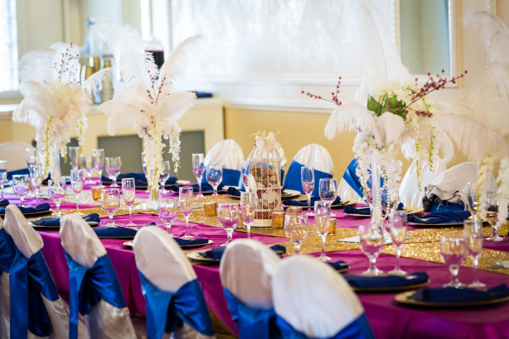 Table setting with feather centerpieces for an article on wedding photography timeline tips