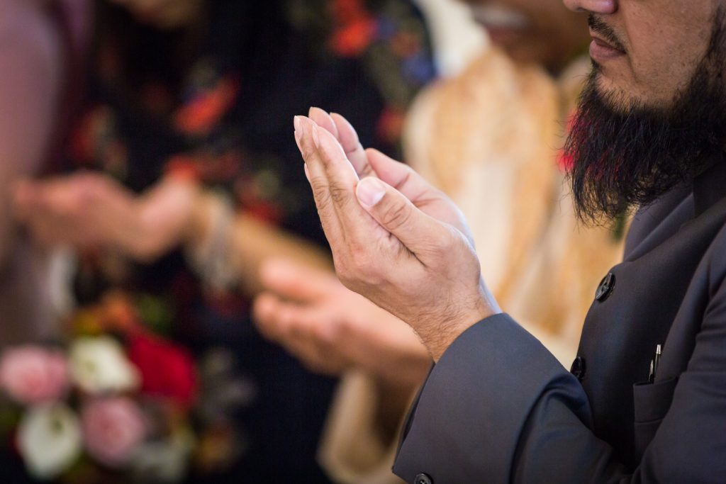 Close up on an imam's hands during Muslim wedding ceremony