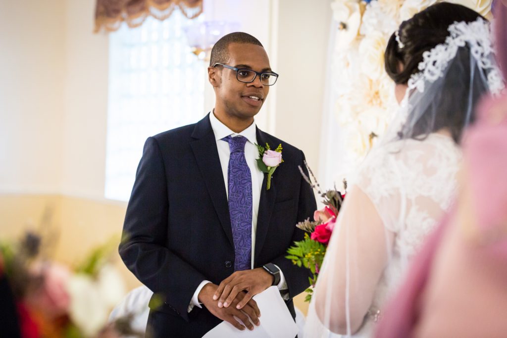 Groom saying vows to bride for an article on wedding photography timeline tips