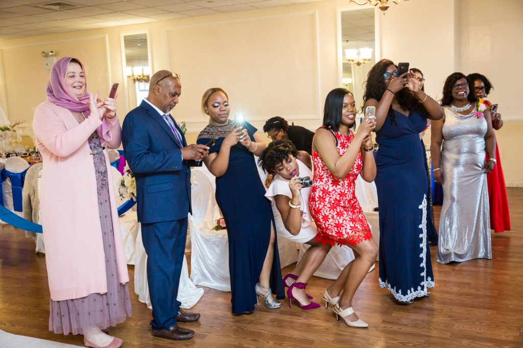 Guests taking photos during wedding ceremony for an article on wedding photography timeline tips