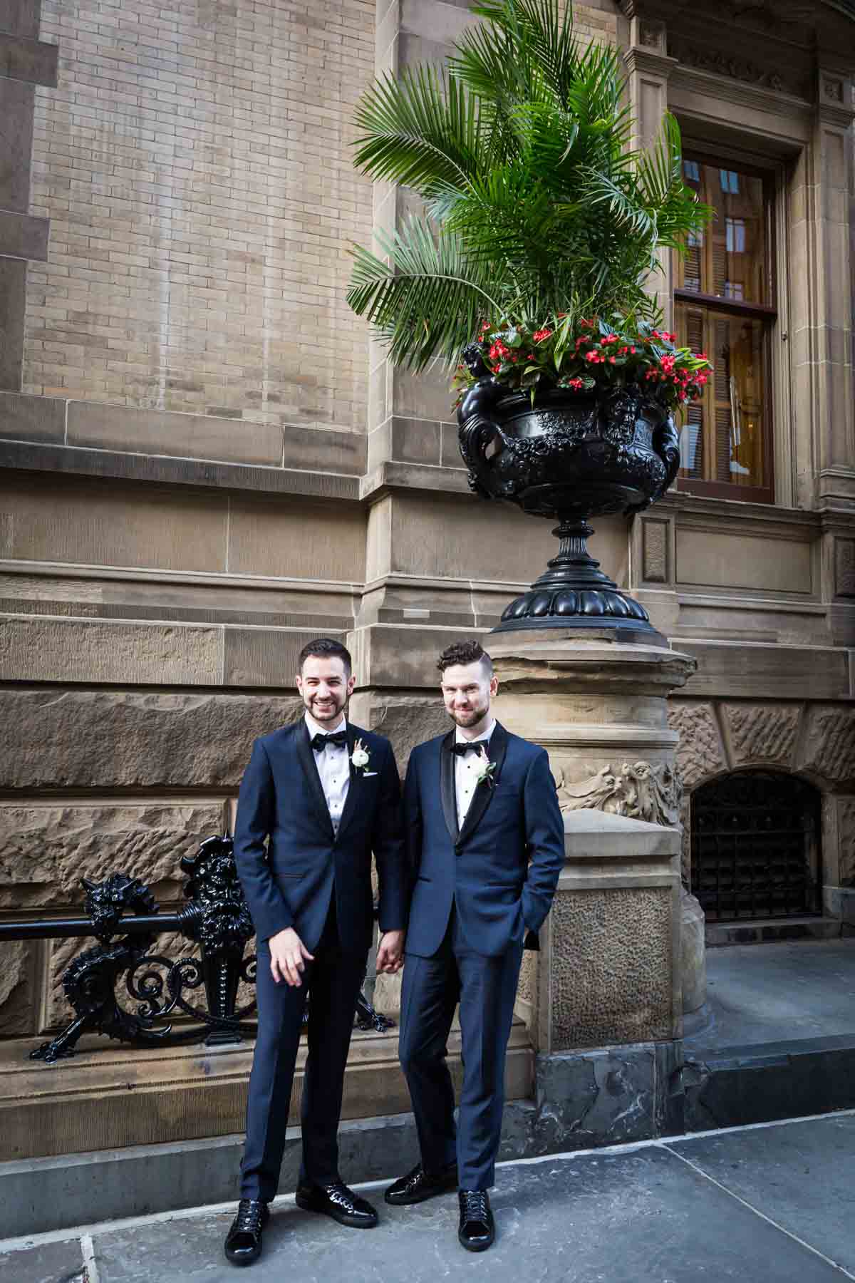 Two grooms in front of the Dakota