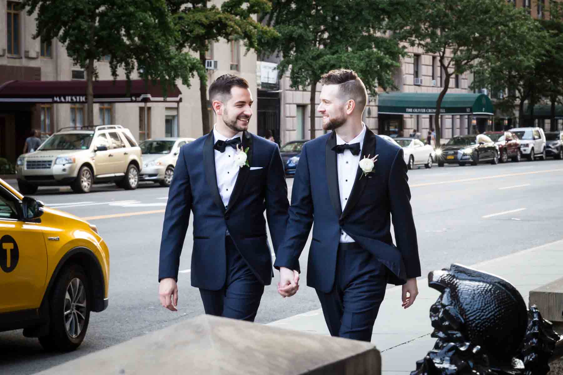 Two grooms walking down 72nd Street The Dakota apartment building