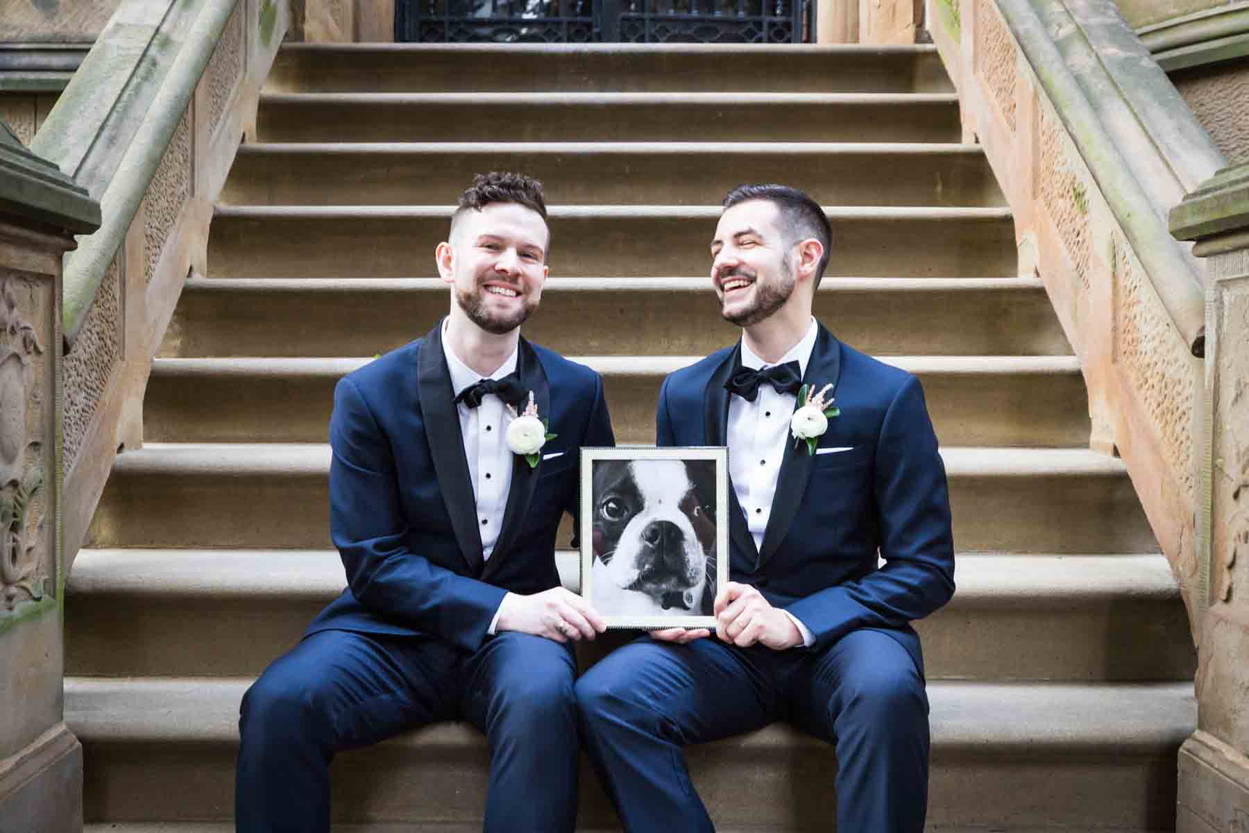 Two grooms sitting on brownstone stairs The Dakota apartment building