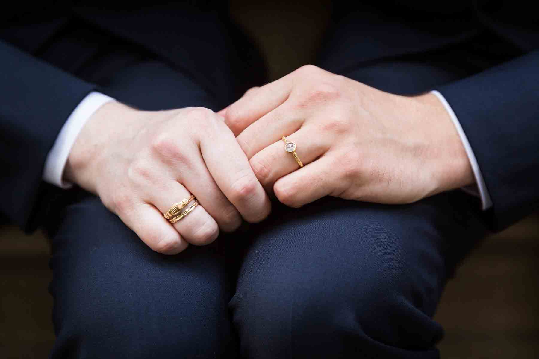 Two grooms holding hands The Dakota apartment building