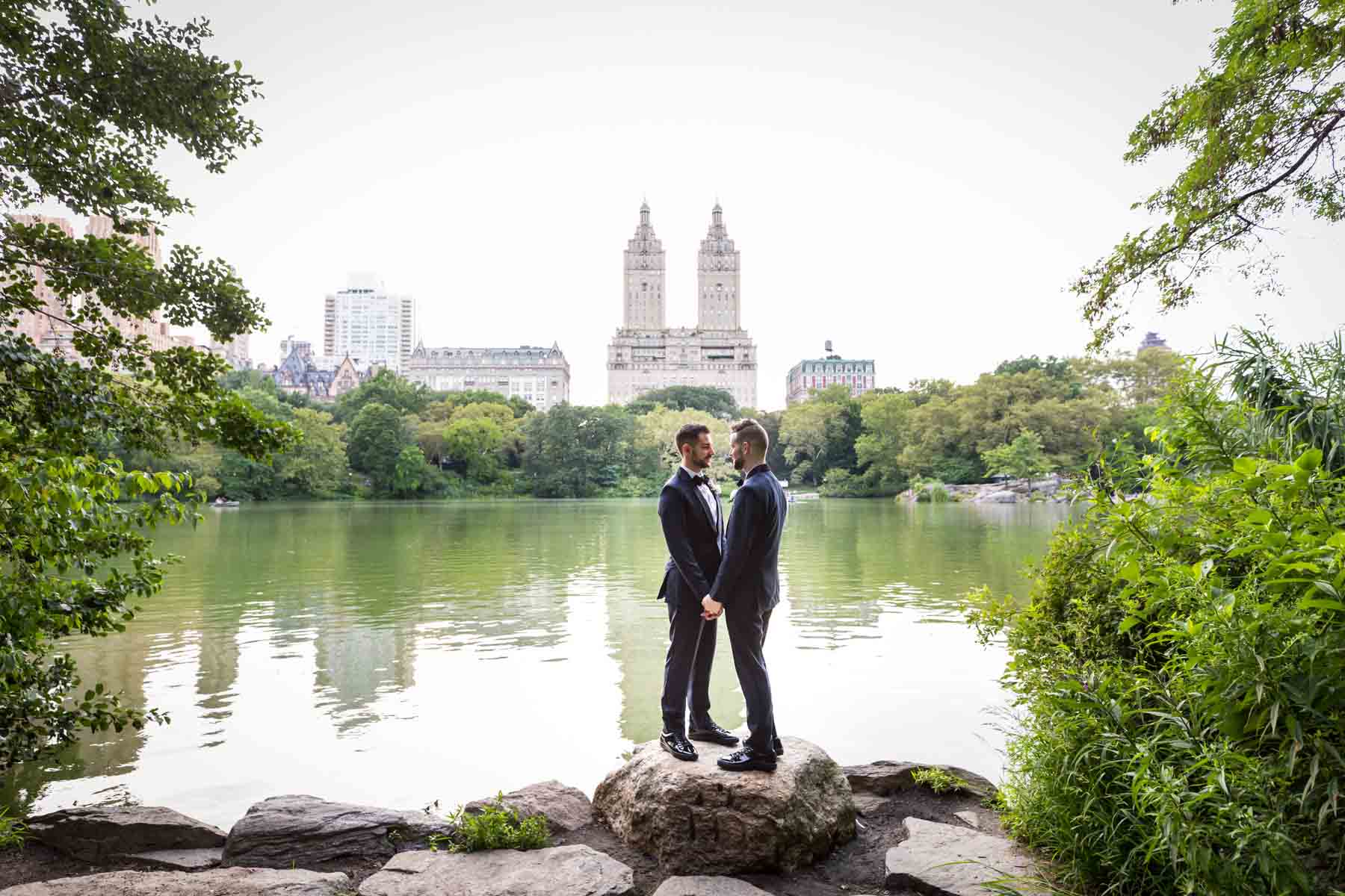 Two grooms in front of Central Park lake for an article entitled, ‘Do you need a permit to get married in Central Park?’