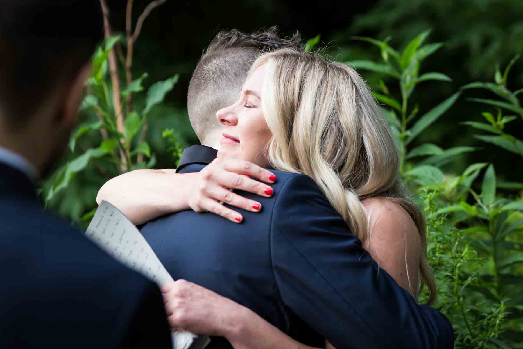 Guest hugging groom for an article entitled, ‘Do you need a permit to get married in Central Park?’