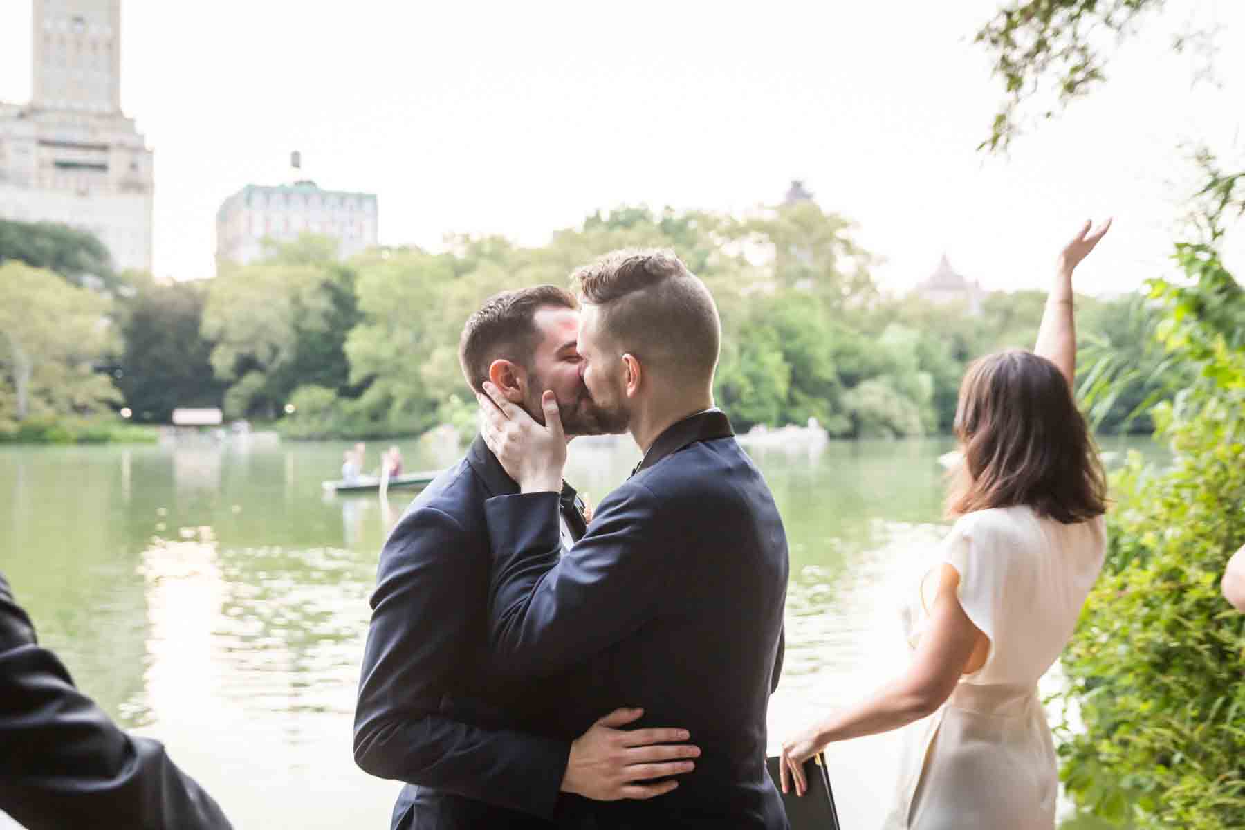 Two grooms kissing for an article entitled, ‘Do you need a permit to get married in Central Park?’