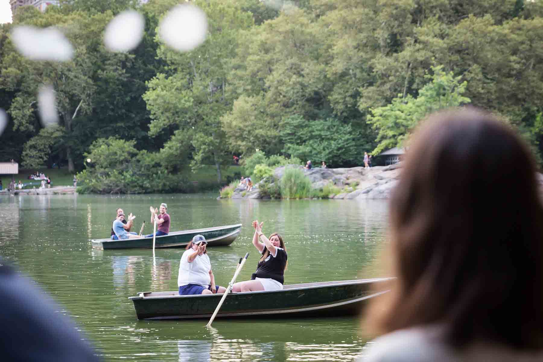 Boaters in Central Park lake clapping for an article entitled, ‘Do you need a permit to get married in Central Park?’