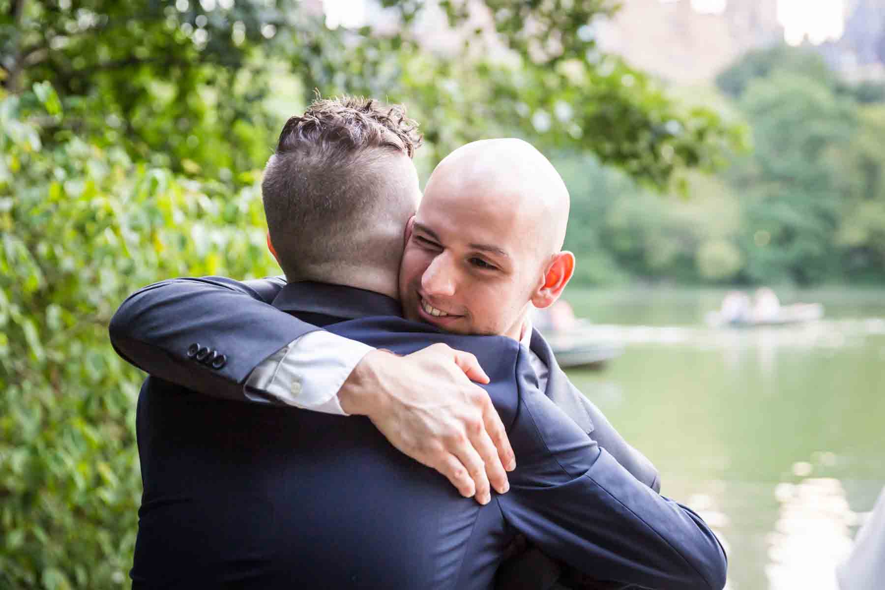 Guest hugging groom for an article entitled, ‘Do you need a permit to get married in Central Park?’