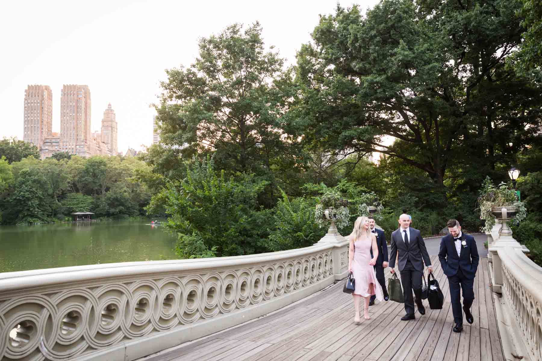 Bridal party walking on Bow Bridge for an article entitled, ‘Do you need a permit to get married in Central Park?’