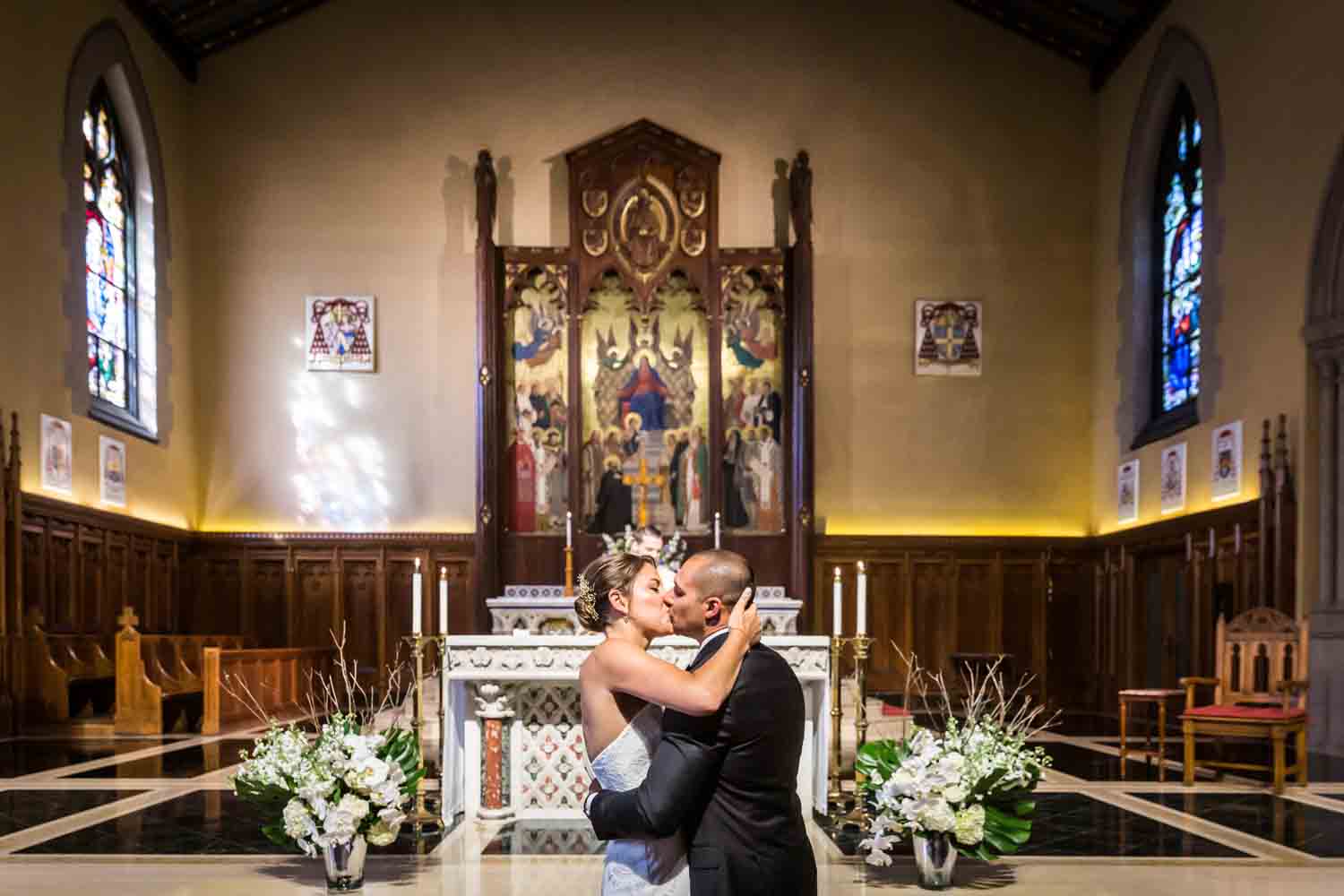 Bride and groom kissing during wedding ceremony for an article on Bronx Zoo wedding venue updates