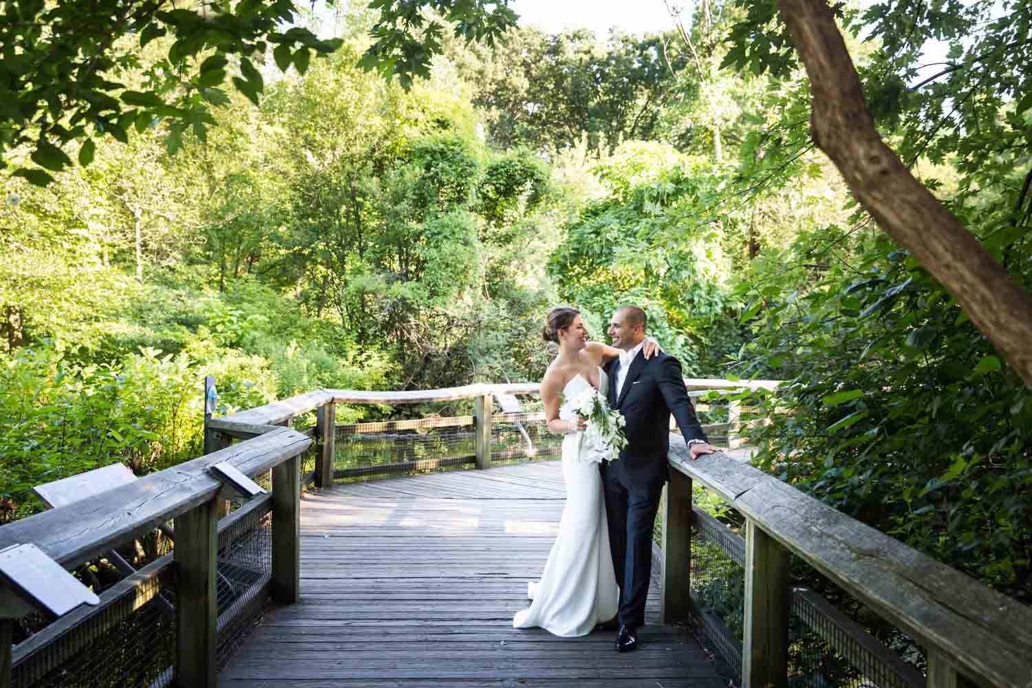 Bride and groom beside flamingo pen for an article on Bronx Zoo wedding venue updates