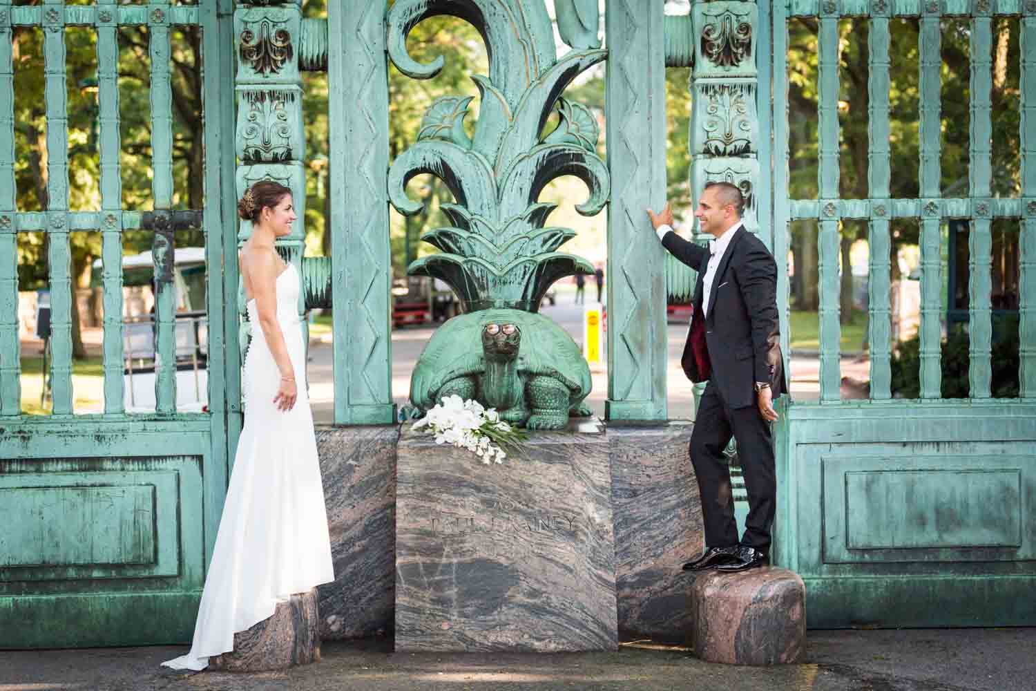 Bride and groom outside Southern Boulevard gates for an article on Bronx Zoo wedding venue updates