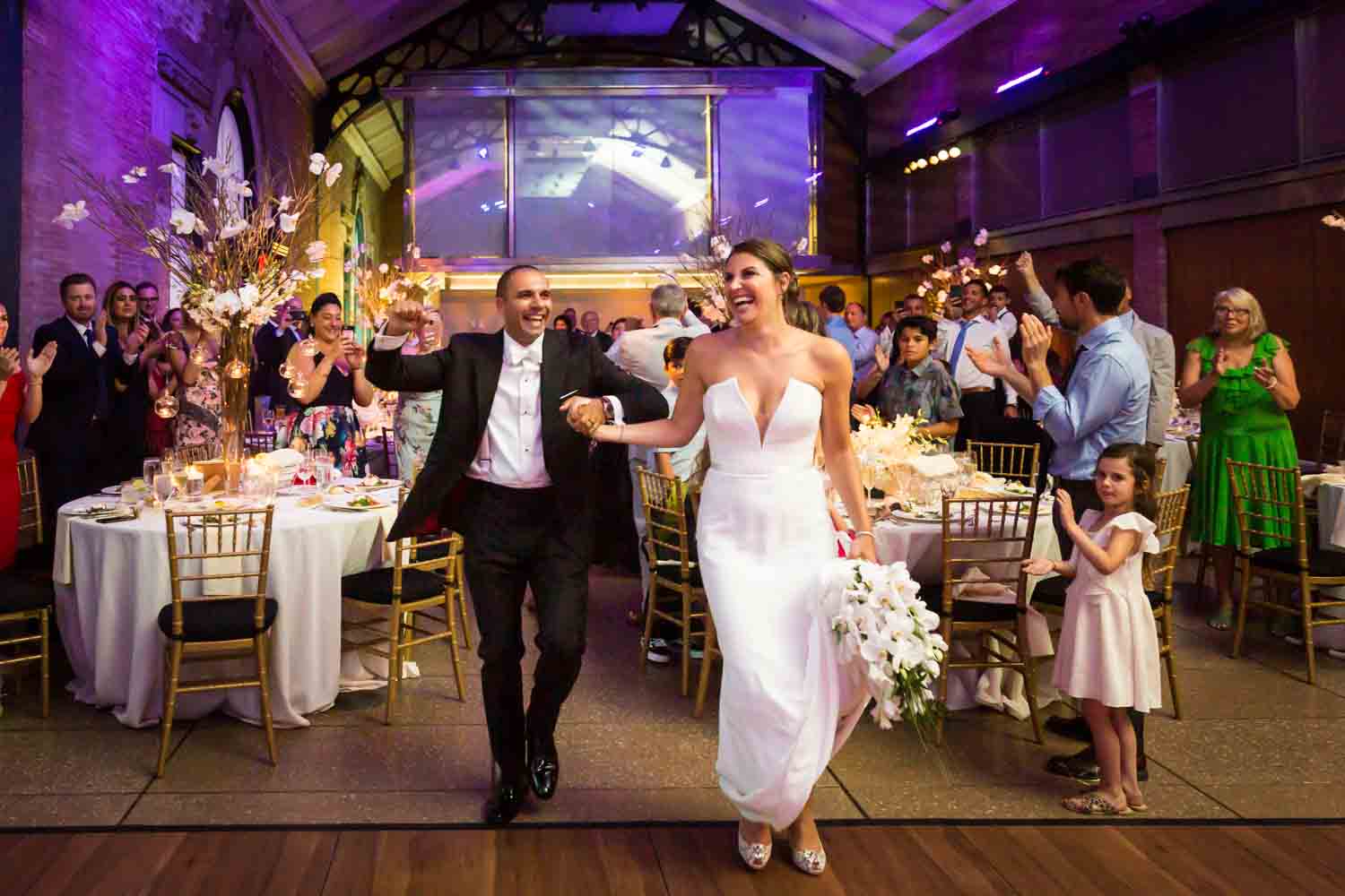 Bride and groom arriving at reception for an article on Bronx Zoo wedding venue updates