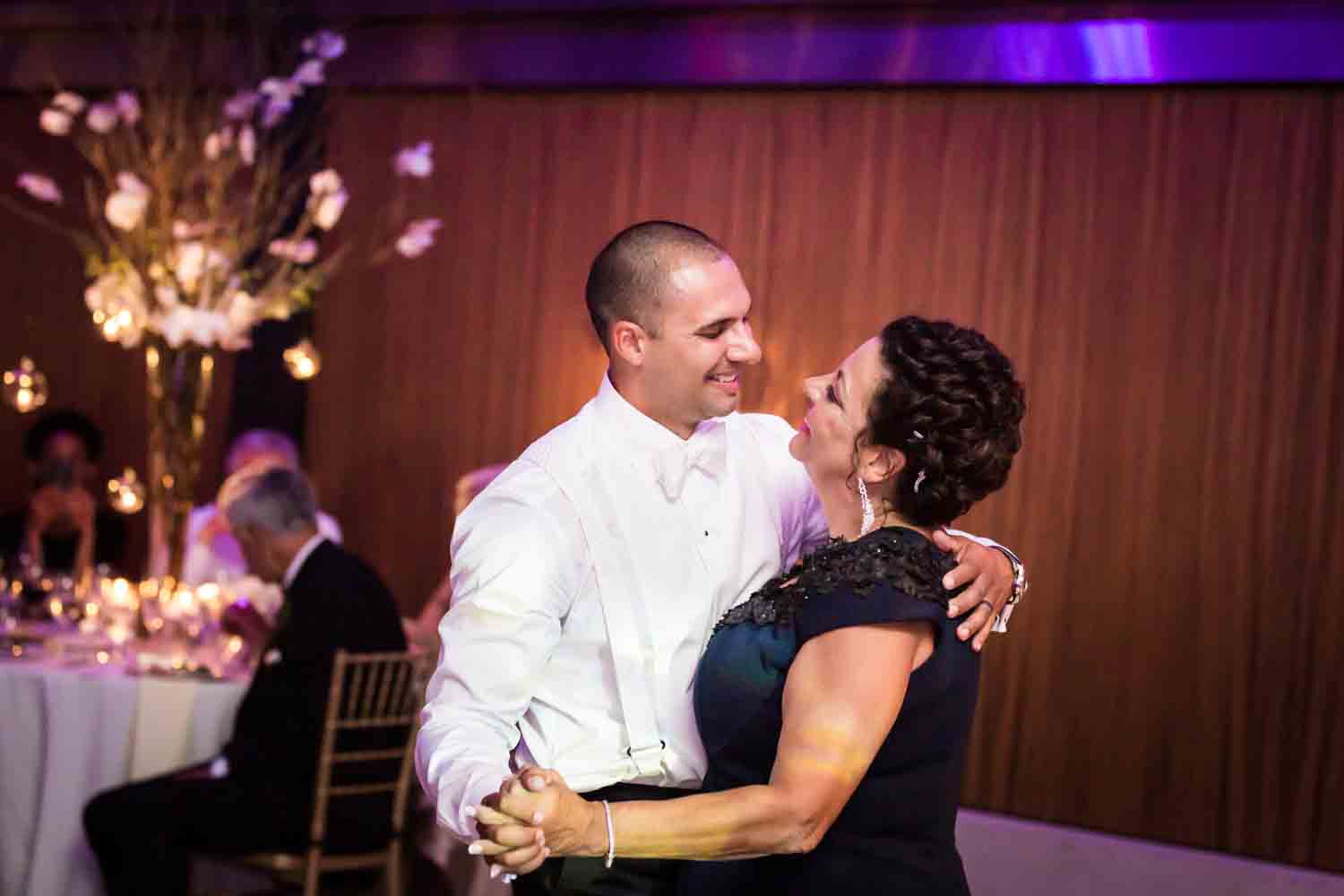 Groom and mother dancing for an article on Bronx Zoo wedding venue updates