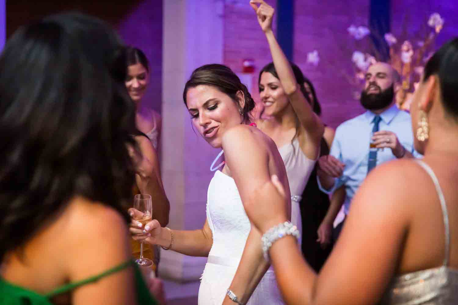 Bride and guests dancing at reception for an article on Bronx Zoo wedding venue updates