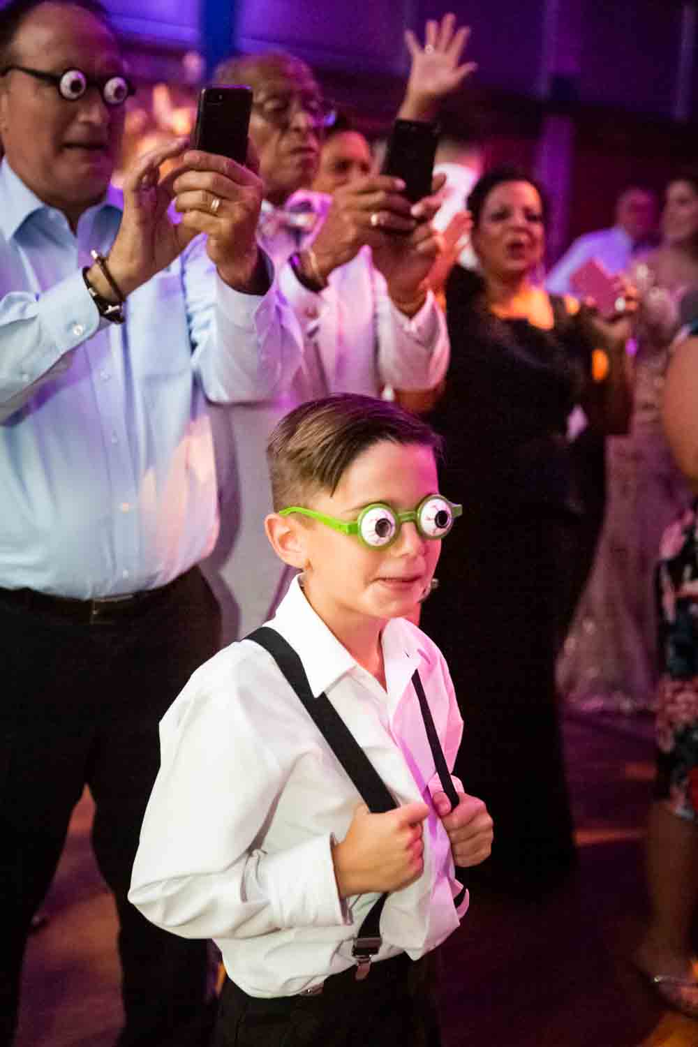 Little boy with fake eye glasses for an article on Bronx Zoo wedding venue updates