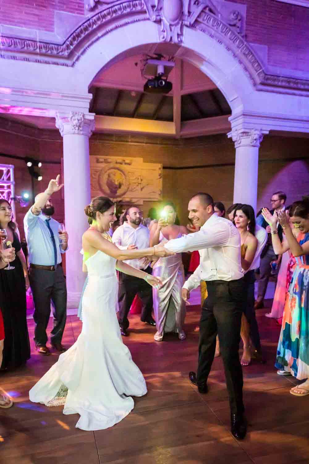 Bride and groom dancing with guests for an article on Bronx Zoo wedding venue updates