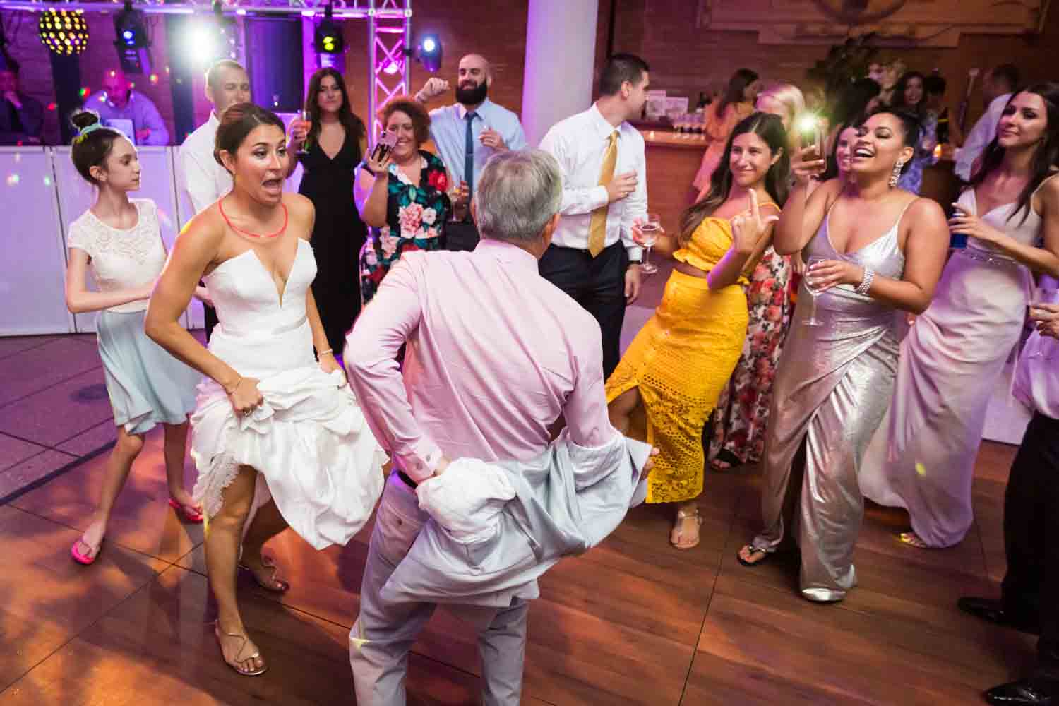Bride dancing with guests for an article on Bronx Zoo wedding venue updates