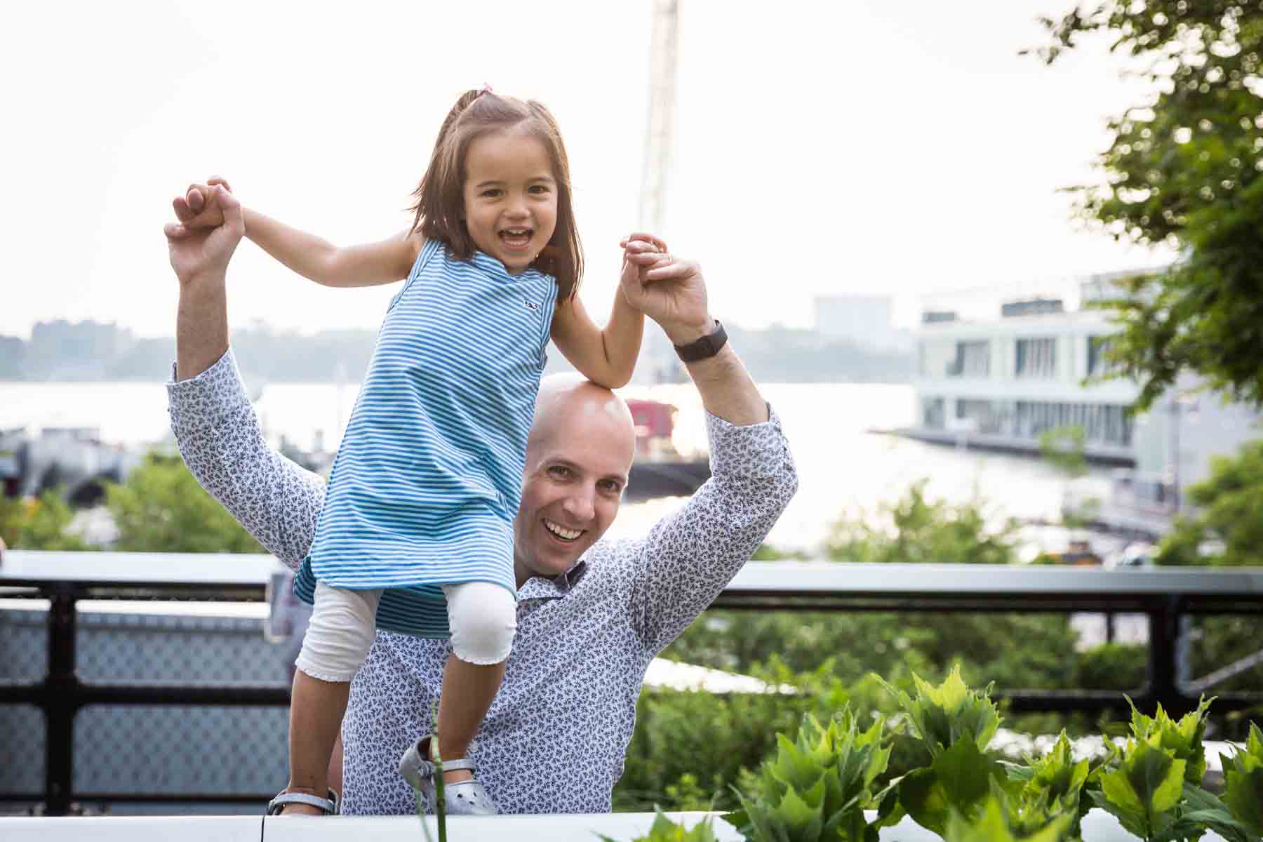 Father holding up little girl for an article on High Line family portrait tips