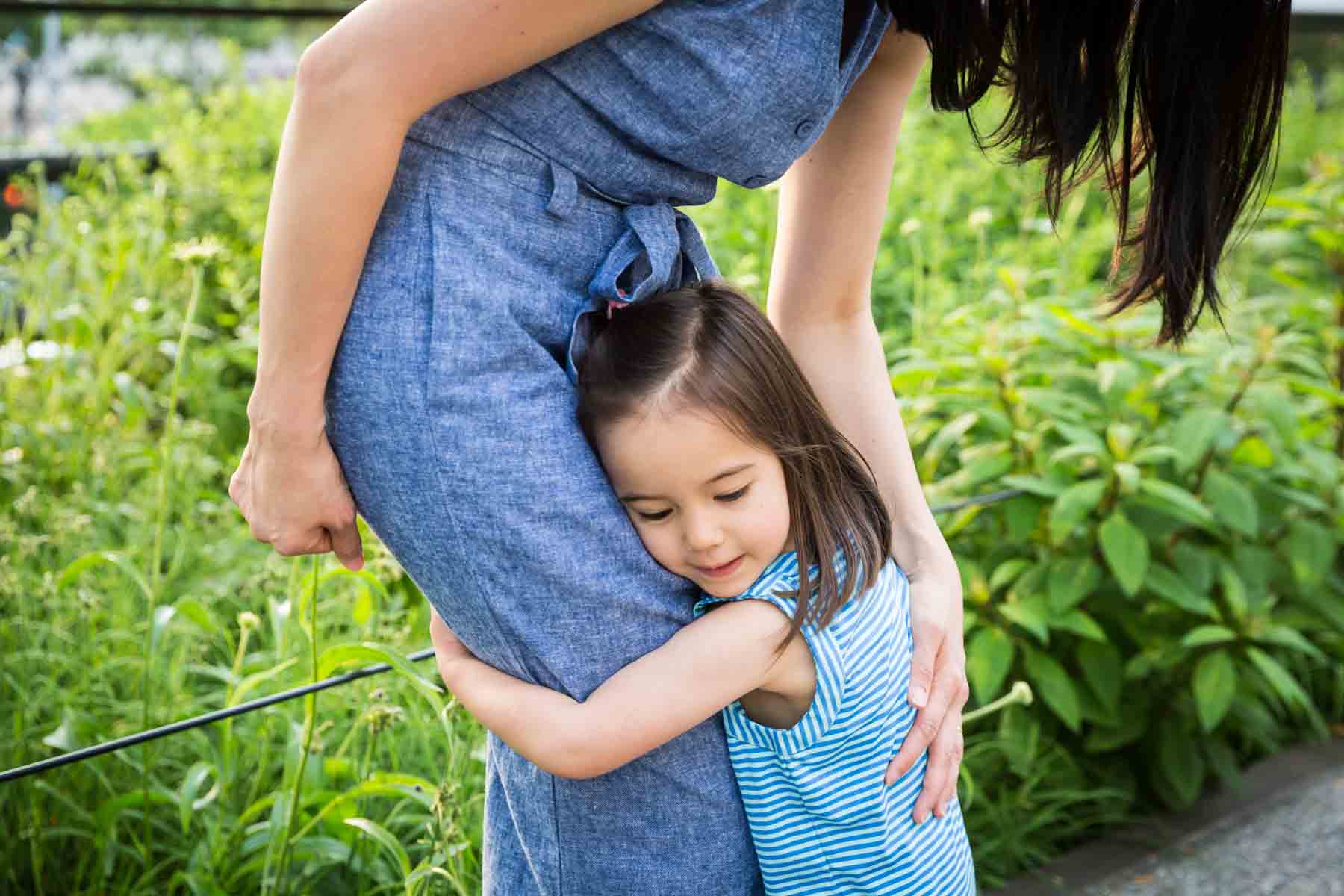 Little girl hugging mother for an article on High Line family portrait tips