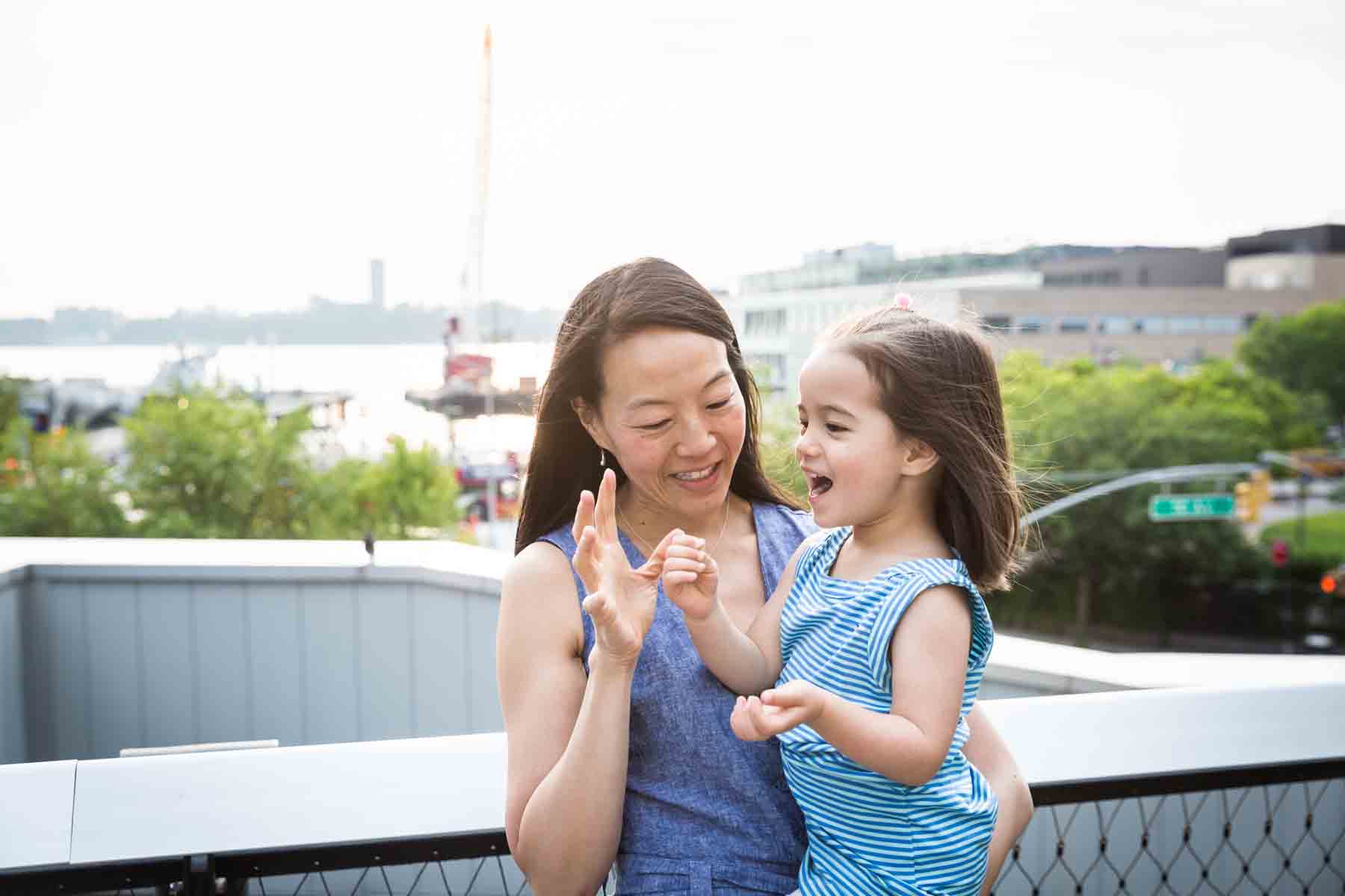 Mother playing with daughter for an article on High Line family portrait tips