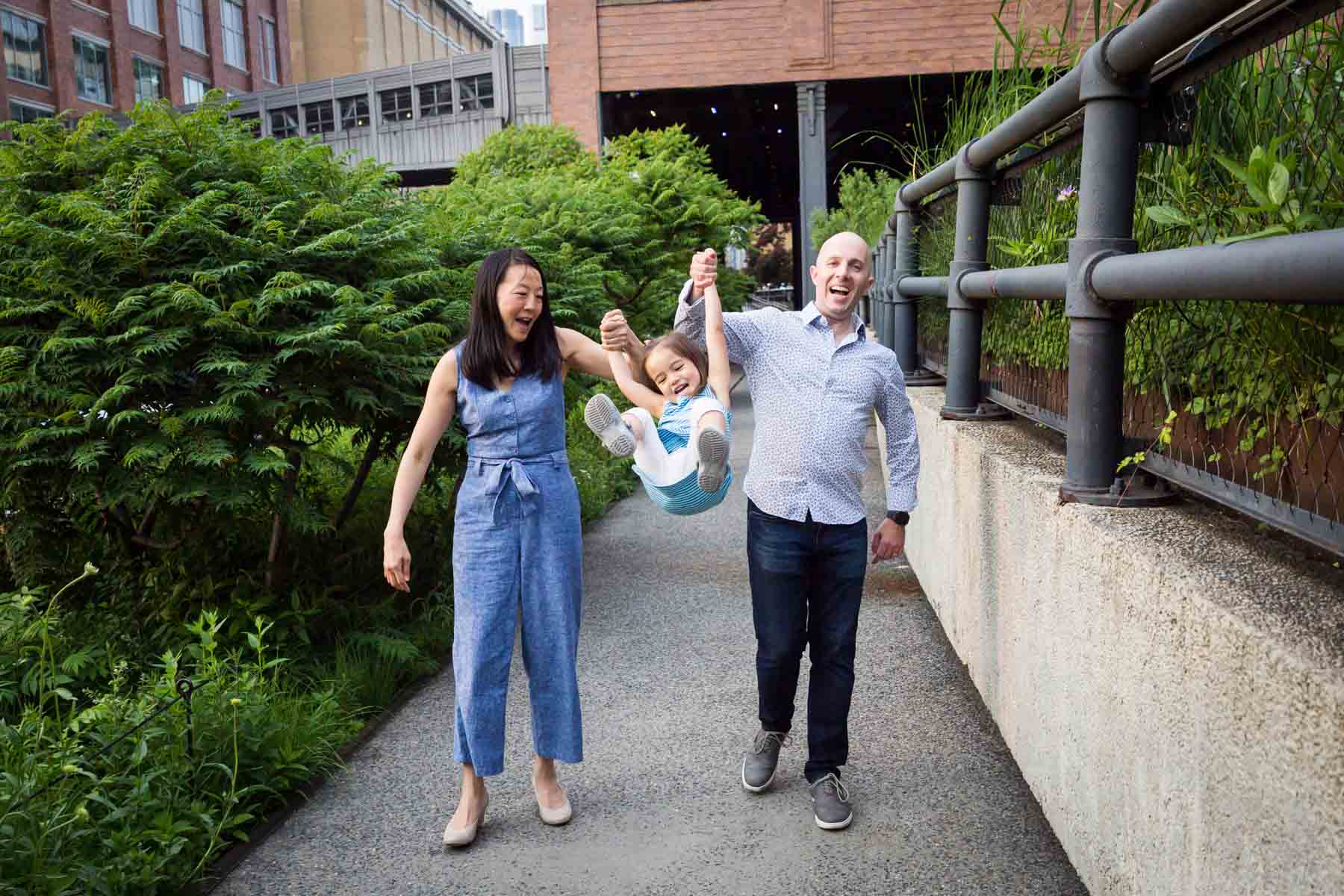 Family swinging daughter for an article on High Line family portrait tips