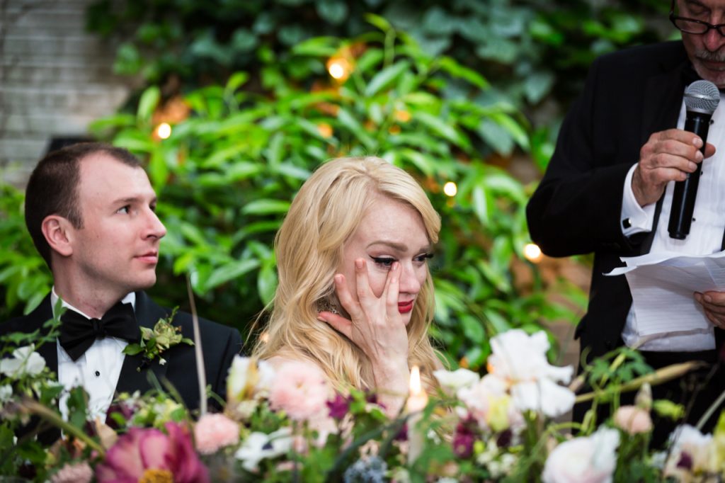 Bride crying during toast at a Central Park Conservatory Garden wedding