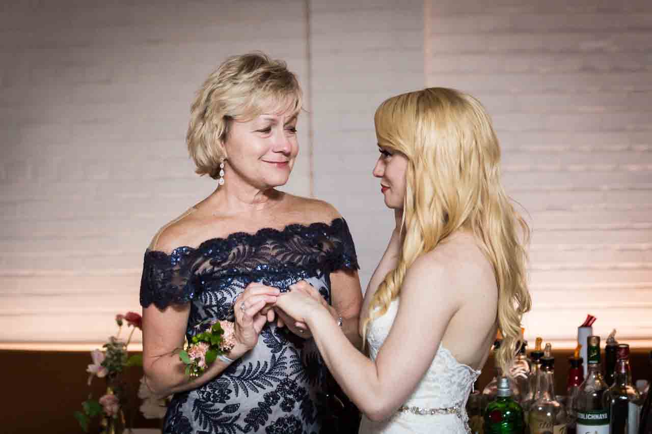 Mother and bride looking at ring at a Central Park Conservatory Garden wedding
