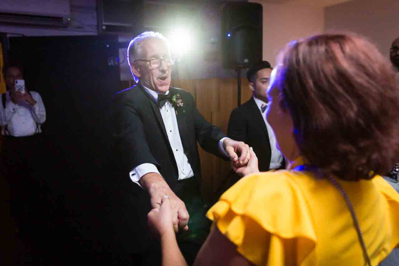 Father and guest dancing at a Central Park Conservatory Garden wedding