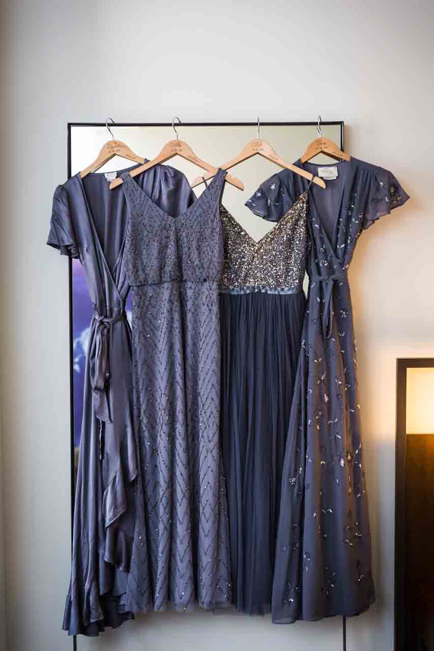 Grey bridesmaid dresses hanging up at a Central Park Conservatory Garden wedding