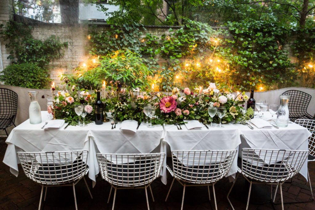 Main table with floral centerpieces at a Central Park Conservatory Garden wedding