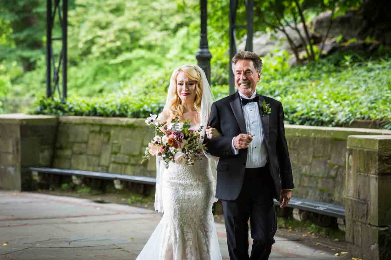 Bride and father walking down aisle at a Central Park Conservatory Garden wedding