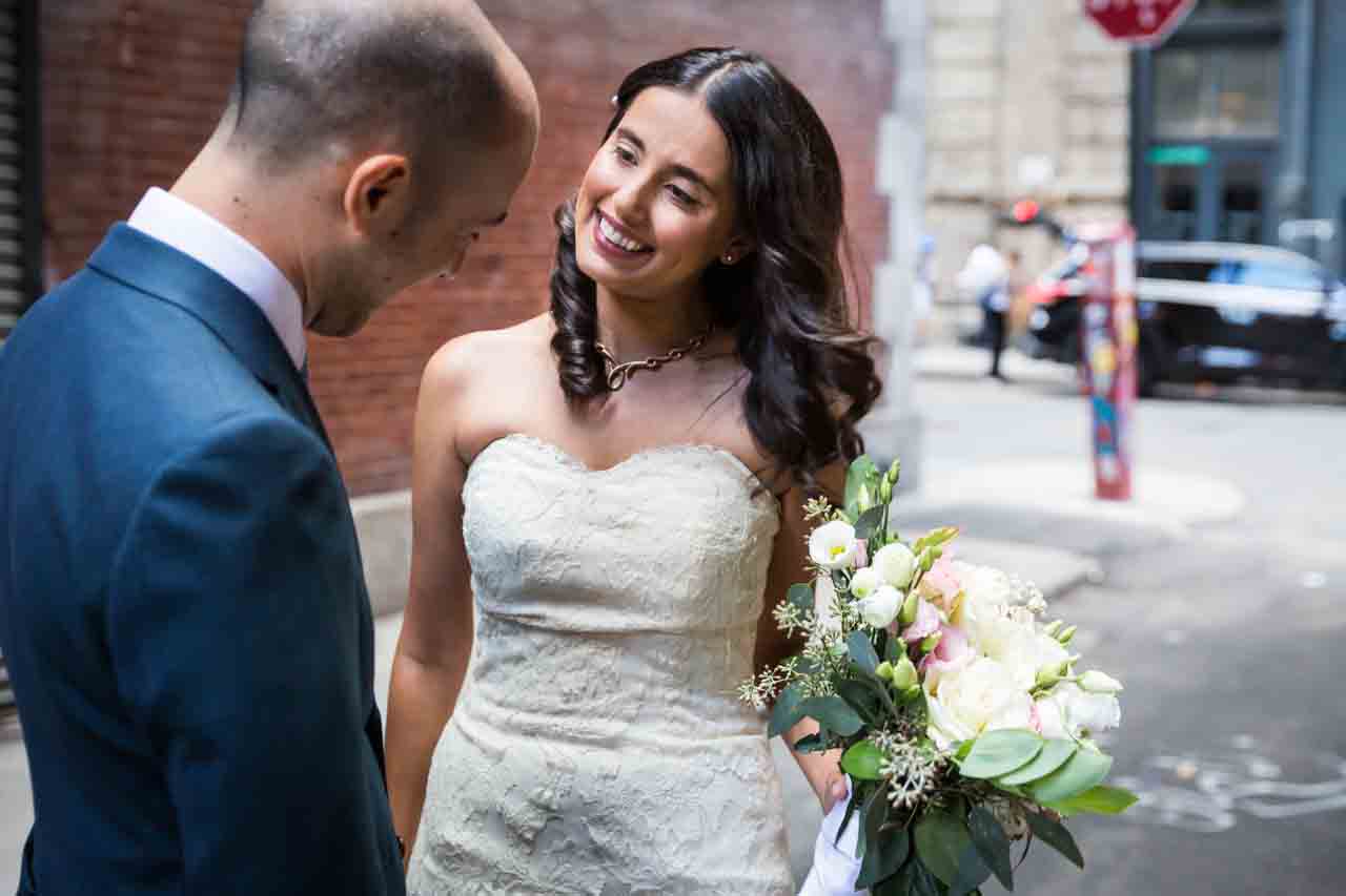 Bride and groom looking at each other for an article on non-floral centerpiece ideas