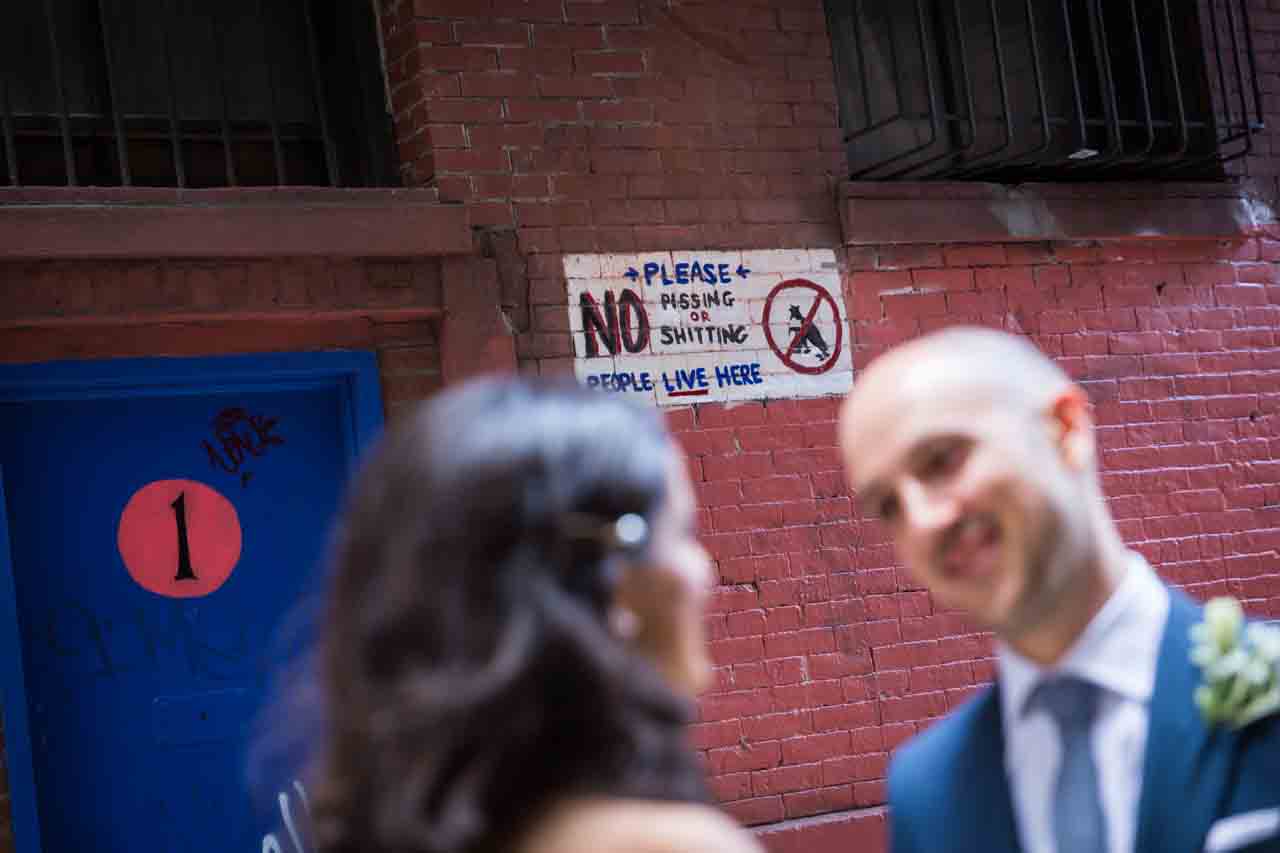 Vulgar sign in NYC alleyway for an article on non-floral centerpiece ideas