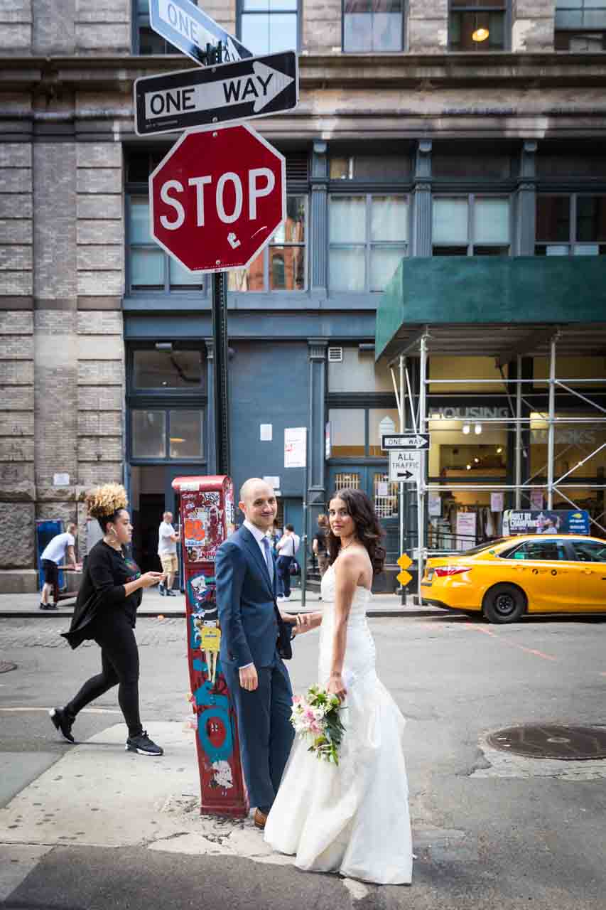 Bride and groom by stop sign for an article on non-floral centerpiece ideas